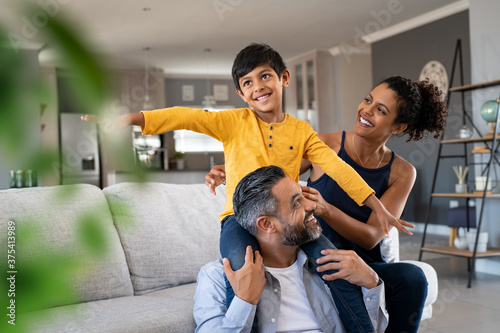 Fotografie Happy son playing with parents at home