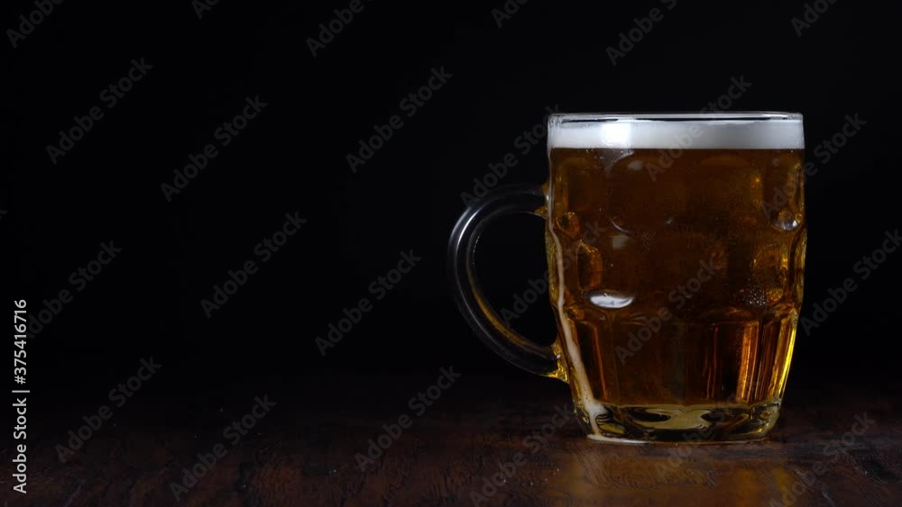 Hand putting beer on the table. Place for your AD text. Hand putting beer on the table. Place for your AD text.