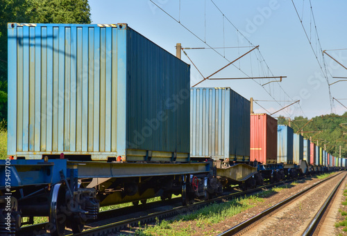 Cargo Containers Transportation On Freight Train By Railway. Intermodal Container On Train Car. Rail Freight Shipping Logistics Concept. Import - export goods from Сhina. Motion, Out of focus