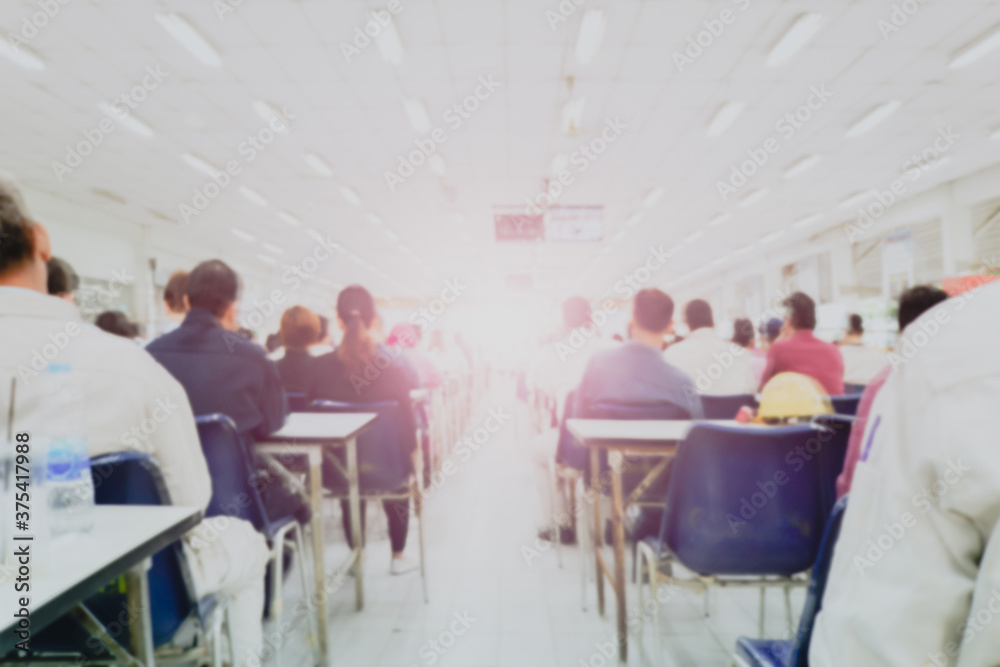 Rear view of Audience in the conference hall or seminar meeting which have Speakers on the stage, business and education about investment concept