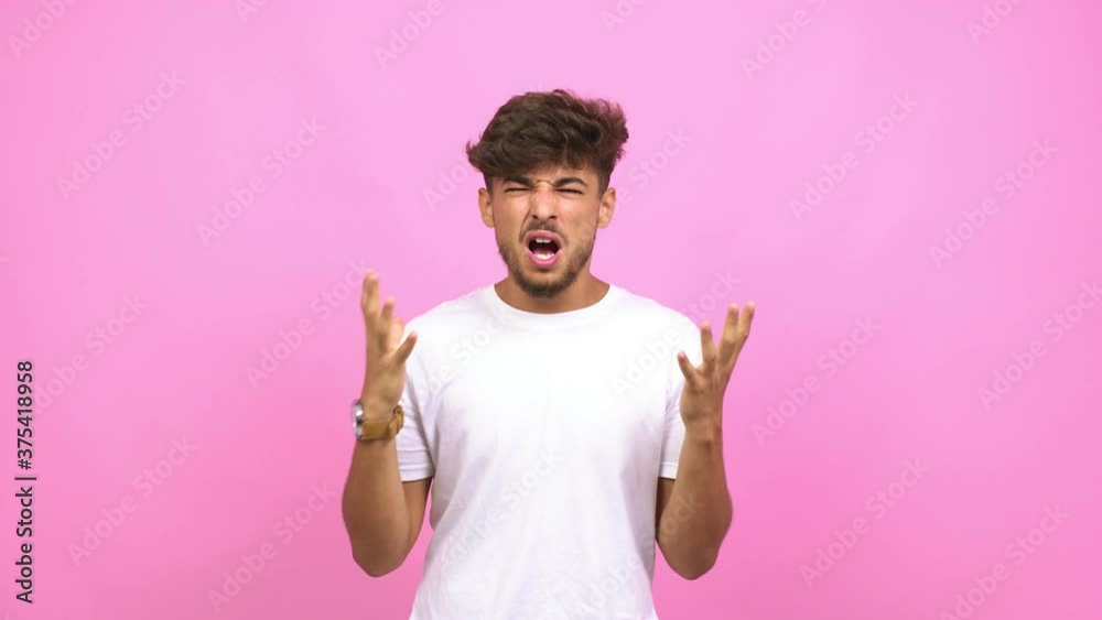 Young arab man very scared and afraid, desperate for something, cries of suffering and open eyes