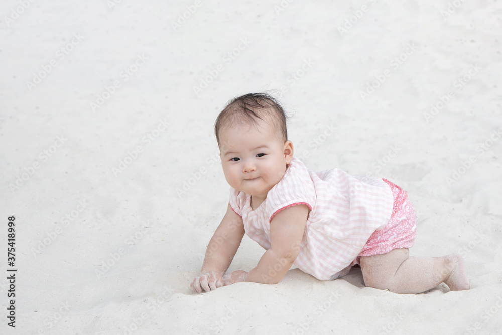 Asian Baby Crawling on the Sand Asian Baby Crawling on the Sand