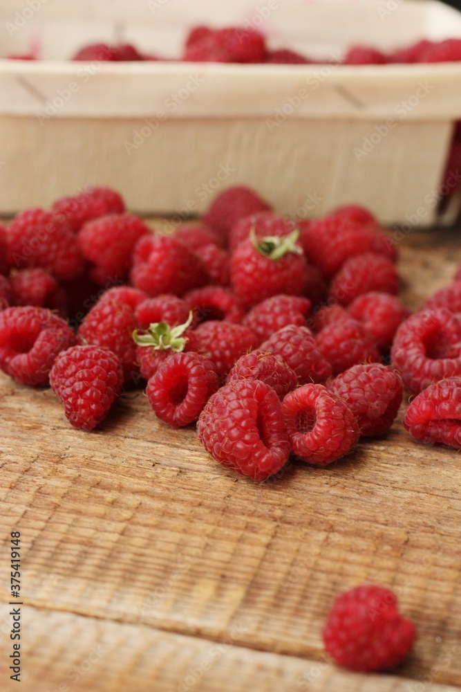 Juicy raspberries on a wooden table macro Juicy raspberries on a wooden table macro