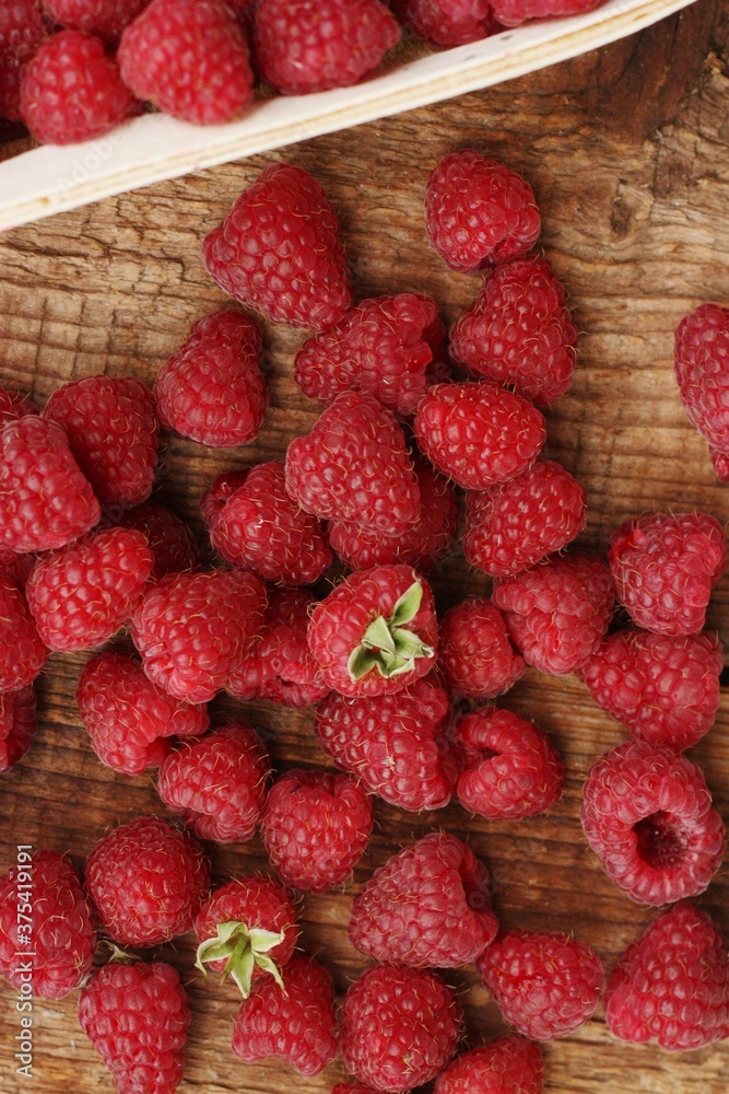 Juicy raspberries on a wooden table macro Juicy raspberries on a wooden table macro
