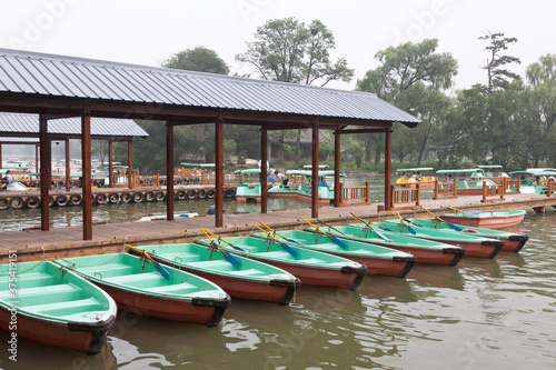 small vessels arranged together in a lake  in the fall