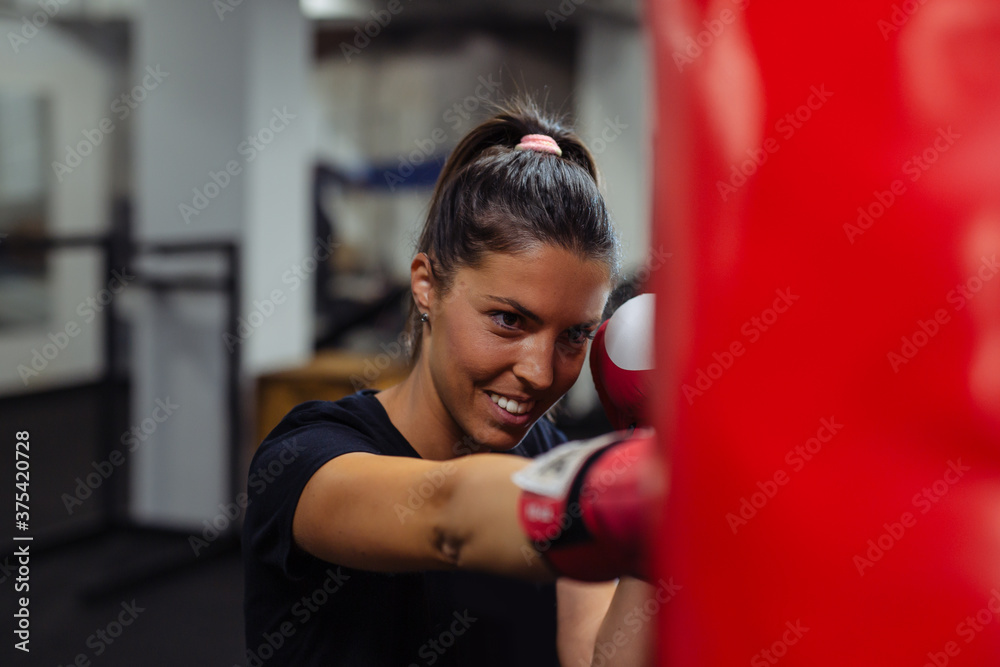 Young woman doing boxing training at the gym.