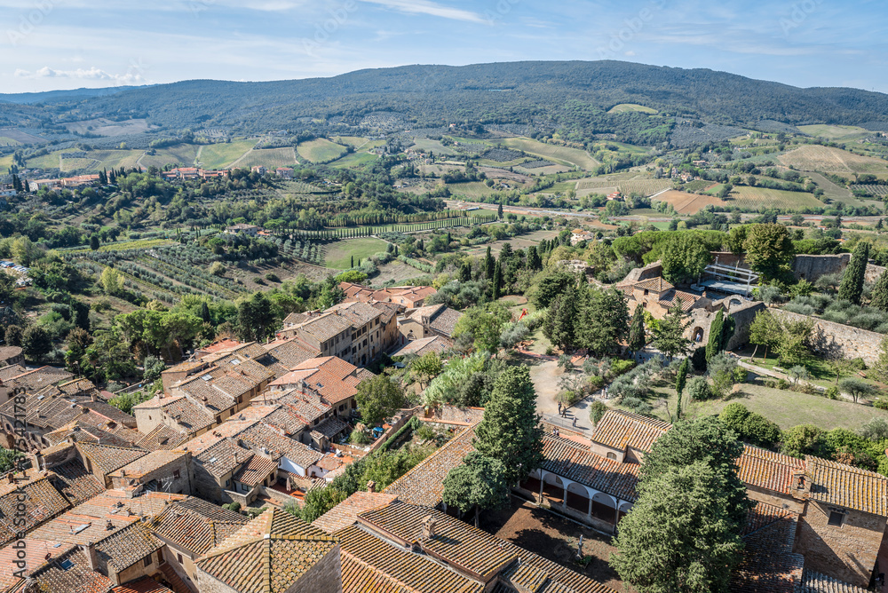 Aerial view of the fields with vineyards, olive groves and cypresses in the vicinity of San Gimignano, Italy