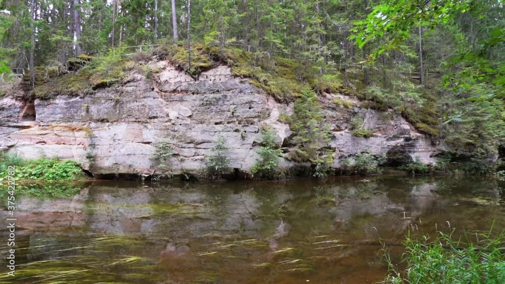 Outcrops of Devonian sandstone on the banks of Ahja river, Estonia. Slow motion 