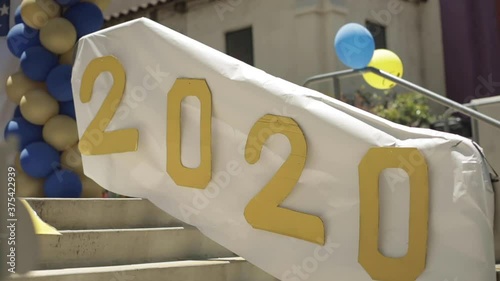 2020 Celebration Sign with Balloons on School Front Steps, Slow Motion photo