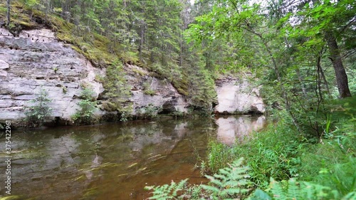 Outcrops of Devonian sandstone on the banks of Ahja river, Estonia. Slow motion  photo