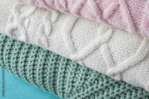 Stack of folded warm sweaters, closeup view