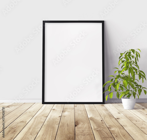 Fototapeta Naklejka Na Ścianę i Meble -  White vertical poster with black wooden frame standing on floor. Template for you design.
