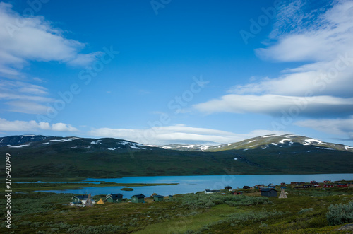 Swedish Lapland landscape. Small village next to lake Alisjavri on Kungsleden and Nordkalottruta Arctic hiking Trail in northern Sweden. Arctic environment of Scandinavia in summer day