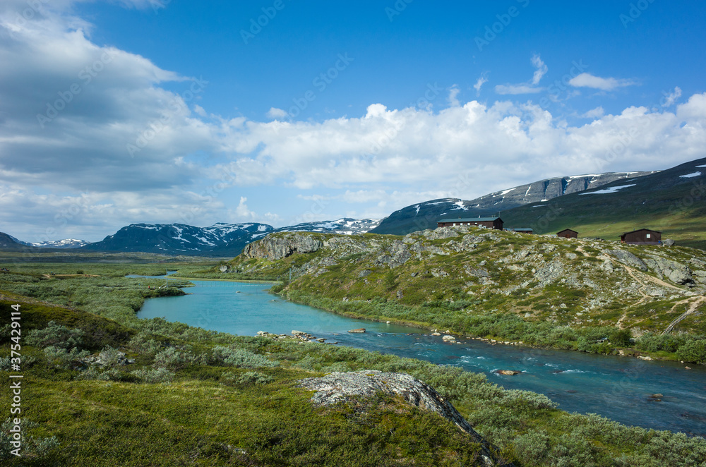 Swedish Lapland landscape. Arctic environment of Scandinavia in summer sunny day. Alesjaure mountain cabins on Kungsleden and Nordkalottruta Arctic hiking Trail in northern Sweden