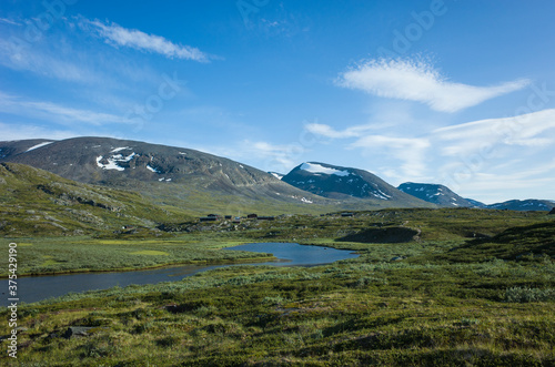 Swedish Lapland landscape. Arctic environment of Scandinavia in warm summer sunny day with blue sky. Alesjaure on Kungsleden and Nordkalottruta Arctic hiking Trail in northern Sweden