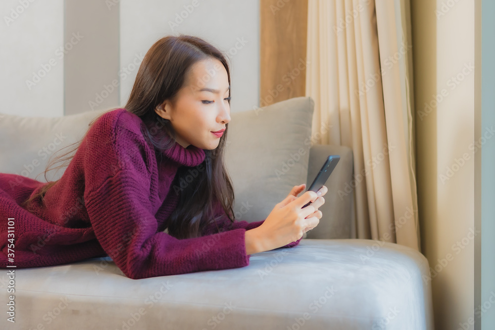 Portrait beautiful young asian woman use smart mobile phone on sofa Portrait beautiful young asian woman use smart mobile phone on sofa