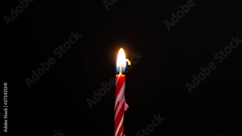 Burning red candle. Time lapse: candle burns.
Stop motion animation. Birthday candle.