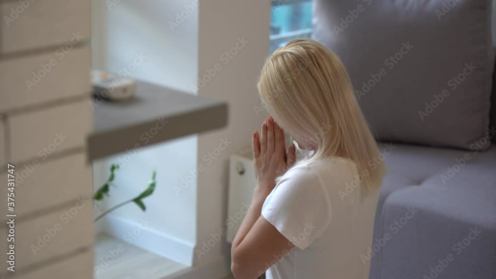 Young woman praying while holding Bible. Woman with Bible praying and reverencing God in her daily devotional at home. 4k Young woman praying while holding Bible. Woman with Bible praying and reverencing God in her daily devotional at home. 4k