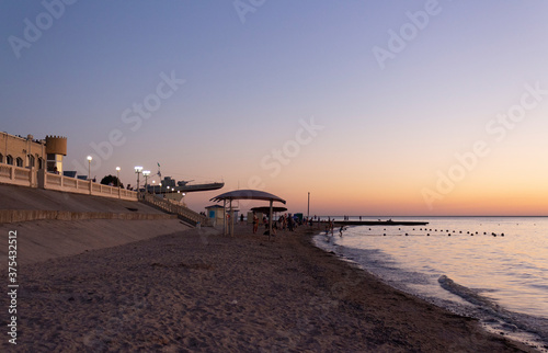 The coast of the Azov Sea and the beach in the city of Primorsko-Akhtarsk, Krasnodar Territory in the summer evening.