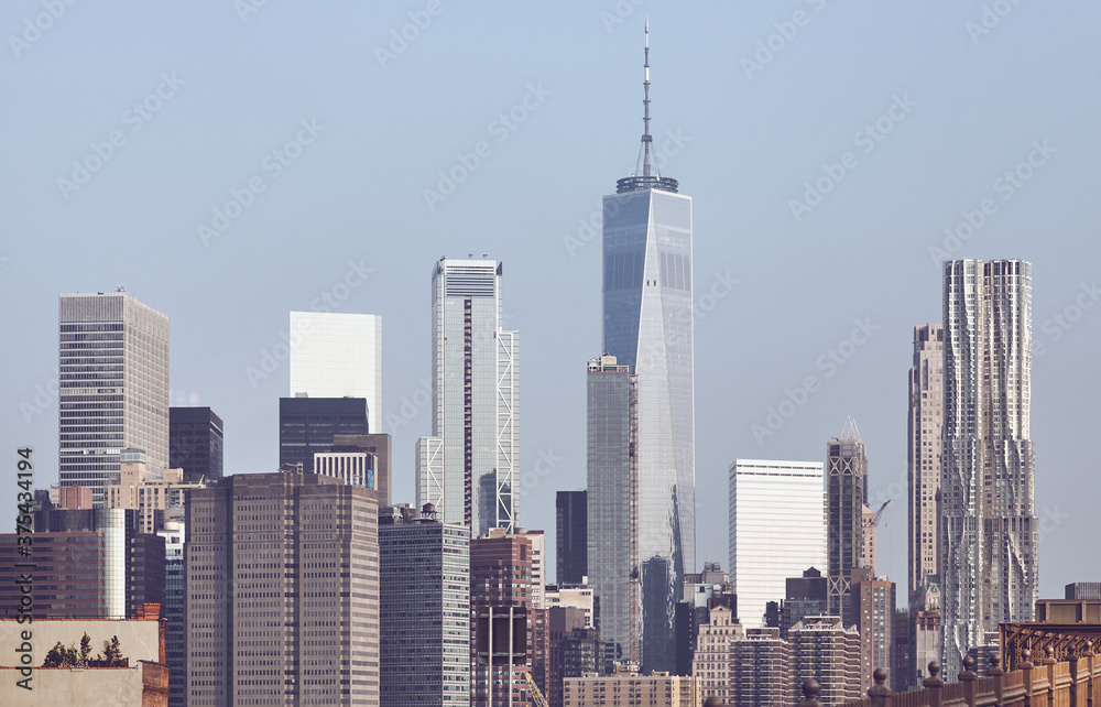 New York City iconic skyline seen from the Brooklyn Bridge, color toned picture, USA.