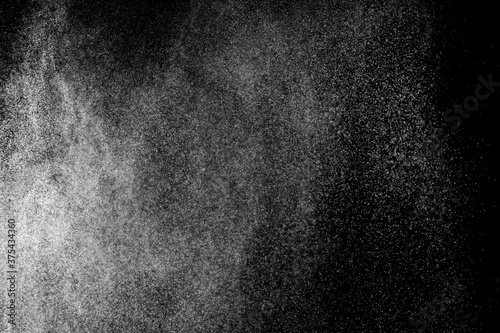 Abstract splashes of water on black background. Freeze motion of white particles. Rain, snow overlay texture.