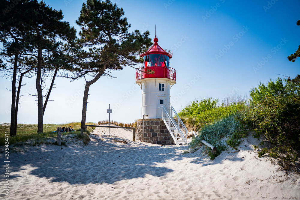 red white lighthouse on the coast