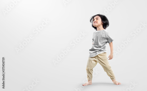 Happy asian boy actively, exicte and dancing against isolated on clean bright background. Education concept for school.
