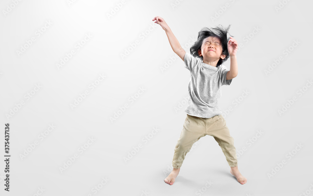 Happy asian boy actively, exicte and dancing against isolated on clean bright background.  Education concept for school.