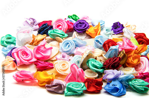 small decorative roses of different colors on a white background