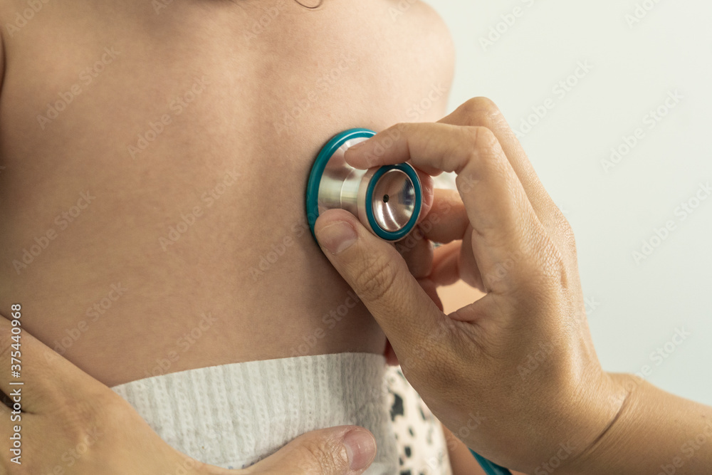 Fototapeta premium Detail of stethoscope checking baby's back at the doctor clinic