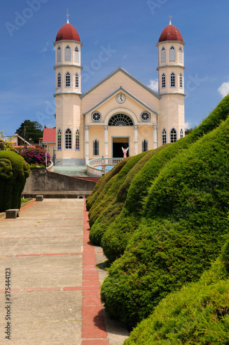 Topiary garden shrubs and path in Zarcero Costa Rica leading to stairs and church photo