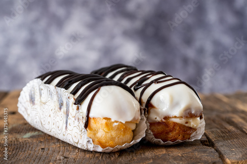 Small eclair with chocolate and cream