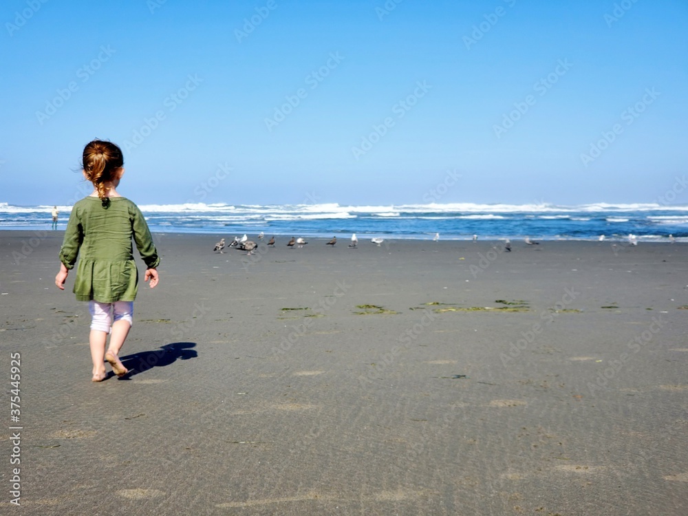 Children playing at the beach of the Pacific Ocean on the coast of Washington State 
