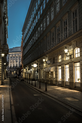 Abandoned Narrow Road With Illuminated Stores In The Inner City Of Vienna In Austria
