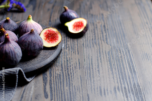 Fig fruits closeup on black kitchen board, copy space
