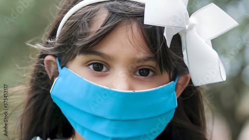 Little girl with protecive face covering due to COVID19 photo