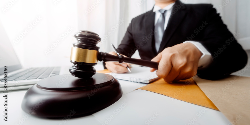 Business and lawyers discussing contract papers with brass scale on desk in office. Law, legal services, advice, justice and law concept picture with film grain effect