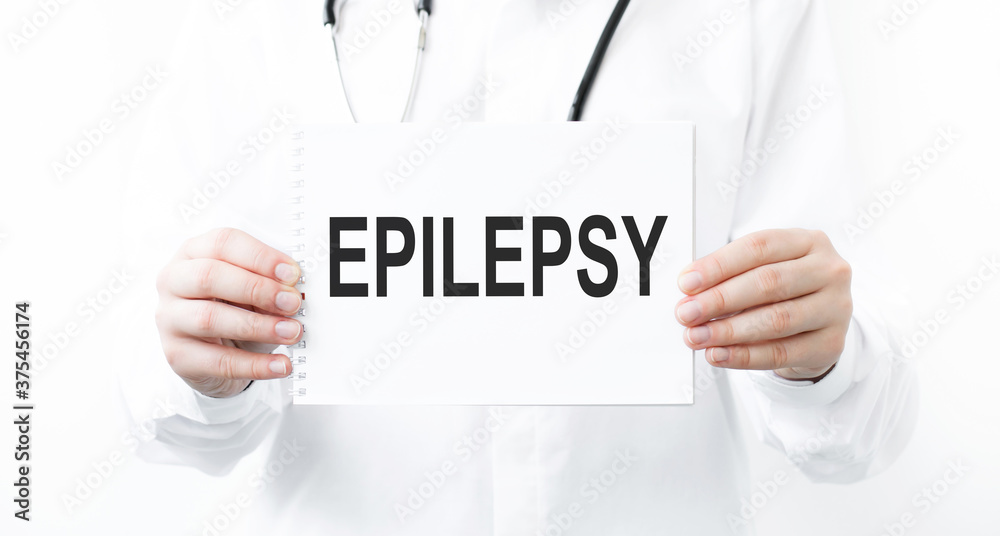 Doctor holding a card with text EPILEPSY, medical concept Doctor holding a card with text EPILEPSY, medical concept
