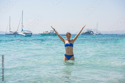 Mallorca island. Young woman in ocean water.
