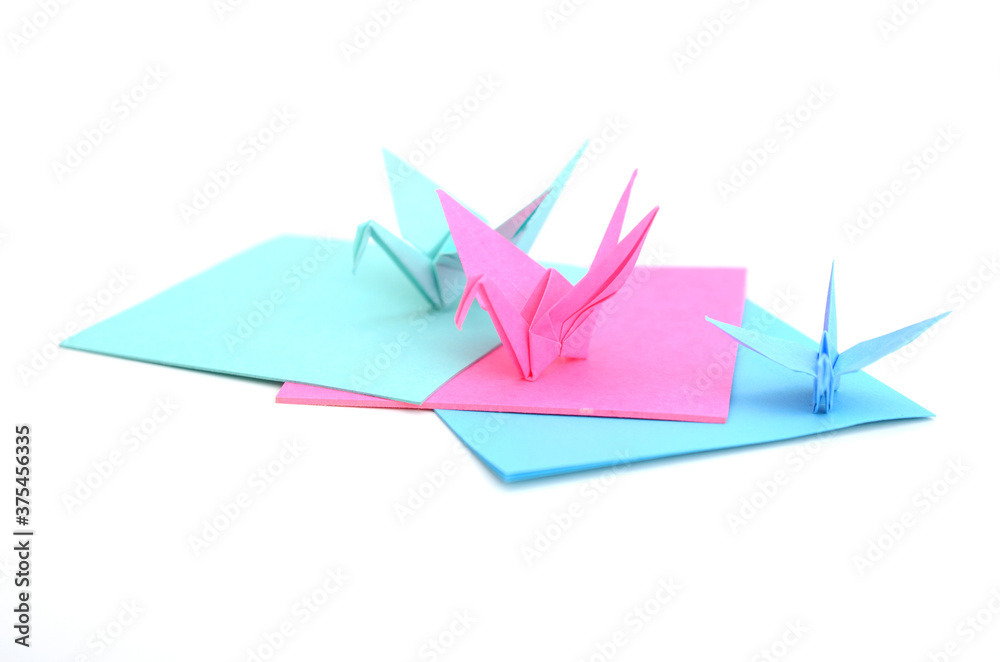 Naklejka premium Origami cranes with paper sheets
