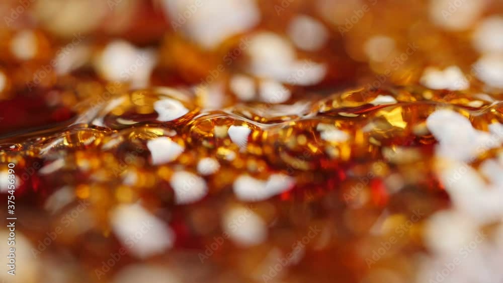 Boiling sugar with bubbles turns into caramel. Shallow depth of field. Slow motion. Boiling sugar with bubbles turns into caramel. Shallow depth of field. Slow motion.