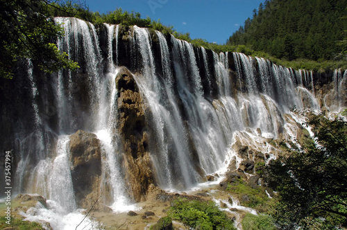 Juizhaigou (Nine Villages Valley) in Sichuan, China. View of Nuorilang Waterfall. Juizhaigou is a popular tourist destination in China famous for its waterfalls, lakes and scenic beauty. photo