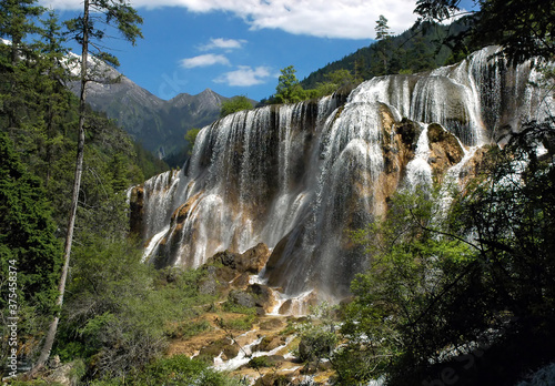 Juizhaigou (Nine Villages Valley) in Sichuan, China. View of Pearl Shoal Waterfall. Juizhaigou is a popular tourist destination in China famous for its waterfalls, lakes and scenic beauty. photo