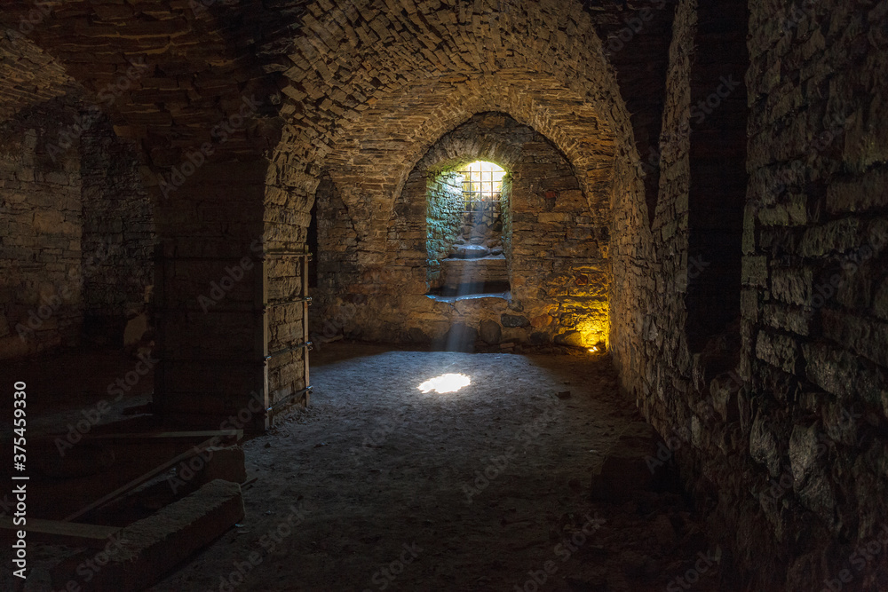 Obraz premium Rays of light shining into the medieval cellar