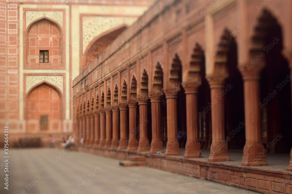 One of the buildings in Taj Mahal complex with arches and columns. Selective focus made with tilt-shift effect. Agra, Uttar Pradesh, India