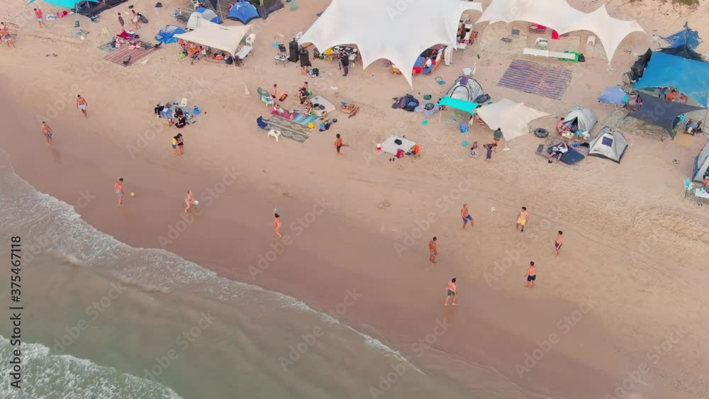 Ball games on a picturesque vibrant sea beach, aerial drone view 4k slow motion, Mikhmoret, Israel Ball games on a picturesque vibrant sea beach, aerial drone view 4k slow motion, Mikhmoret, Israel