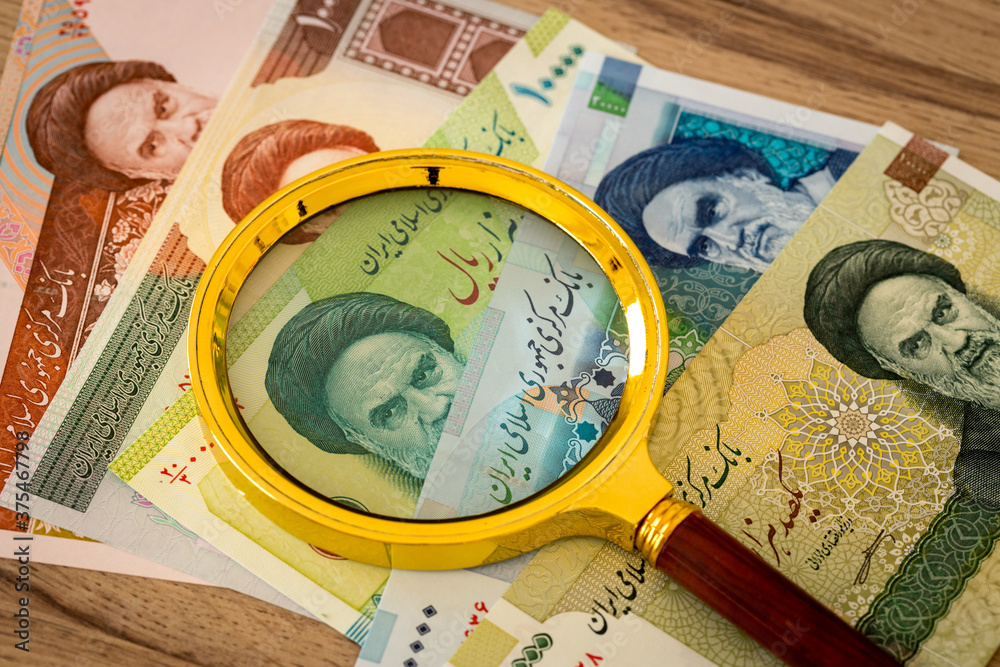 Iranian currency, Rials, Various paper banknotes under a magnifying glass, Country economy concept Iranian currency, Rials, Various paper banknotes under a magnifying glass, Country economy concept