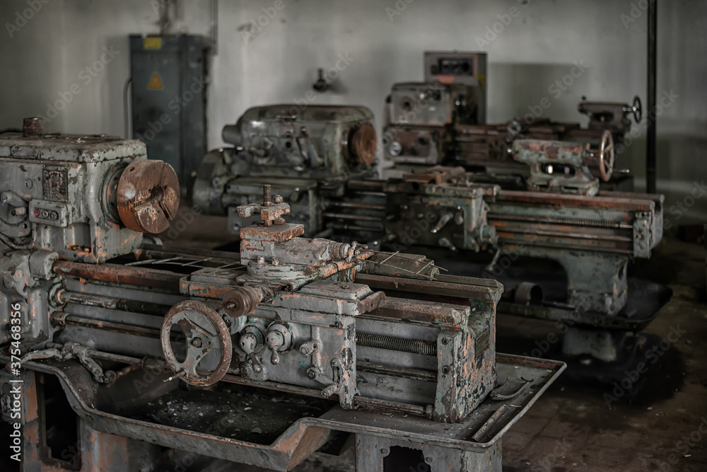 Old broken rusty lathes in the workshop of an abandoned factory Old broken rusty lathes in the workshop of an abandoned factory