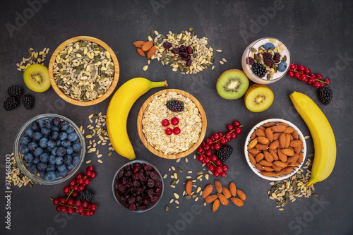 Group Fruits Breakfast with bread Whole grains and nuts, yogurt mix with Cherry , banana, avocado in the wooden table. Breakfast for Health and Diet concept