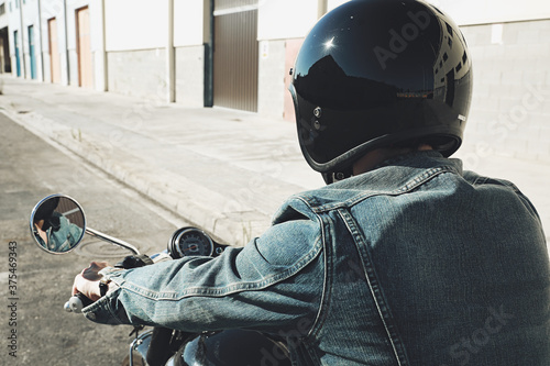 Close-up of biker man riding his bike, back view. Space for text.